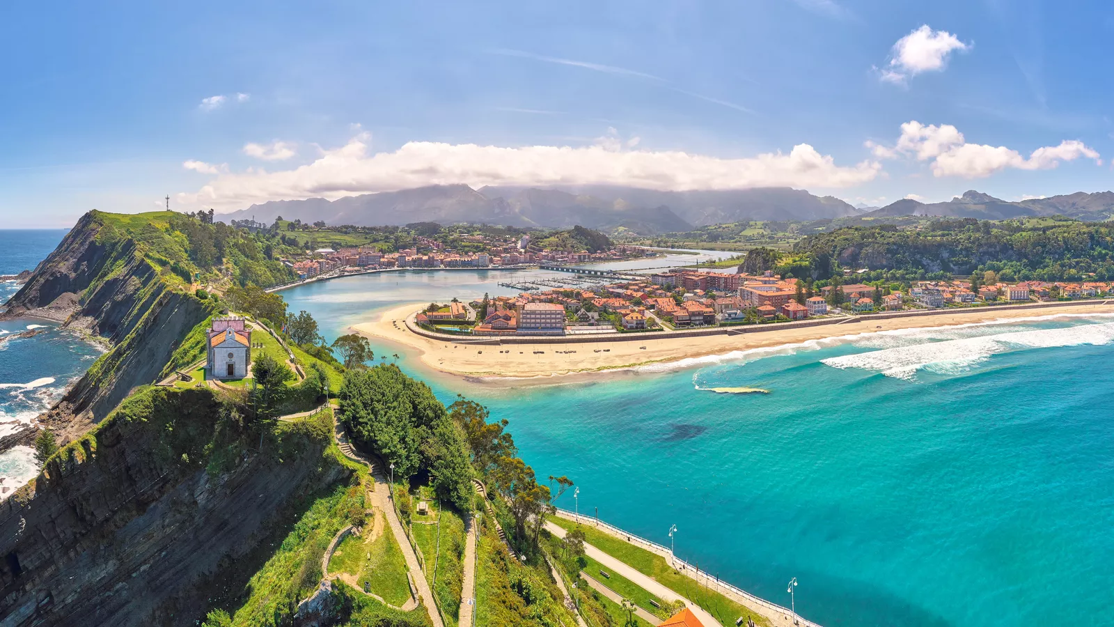 Panoramic view of Ribadesella, Spain, with the Guía chapel on the headland, the Sella estuary and Santa Marina beach